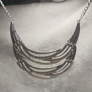 Silver Multi-Tiered Crescent Necklace with Textured Bars